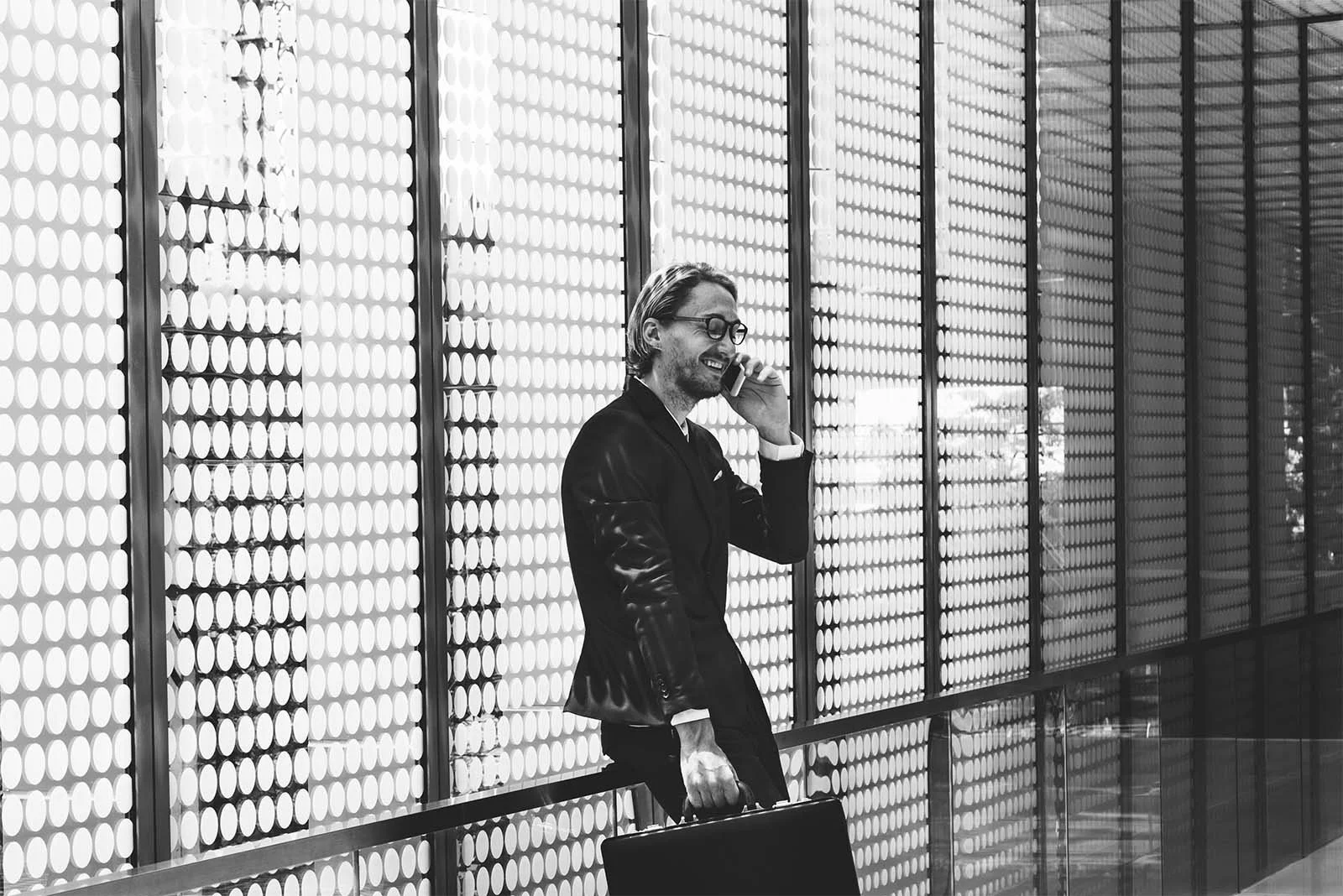 Sales comp professional discussing incentive compensation strategy while holding a briefcase.