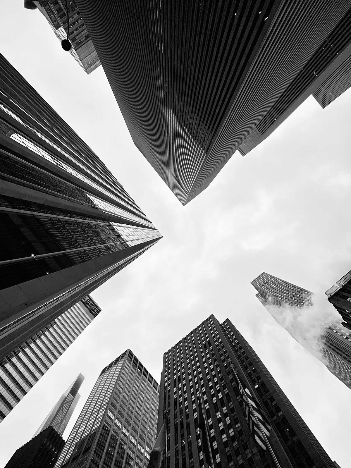 Looking up between high-rise office buildings, representing the scaling B2B organizations IncentiveOps serves.
