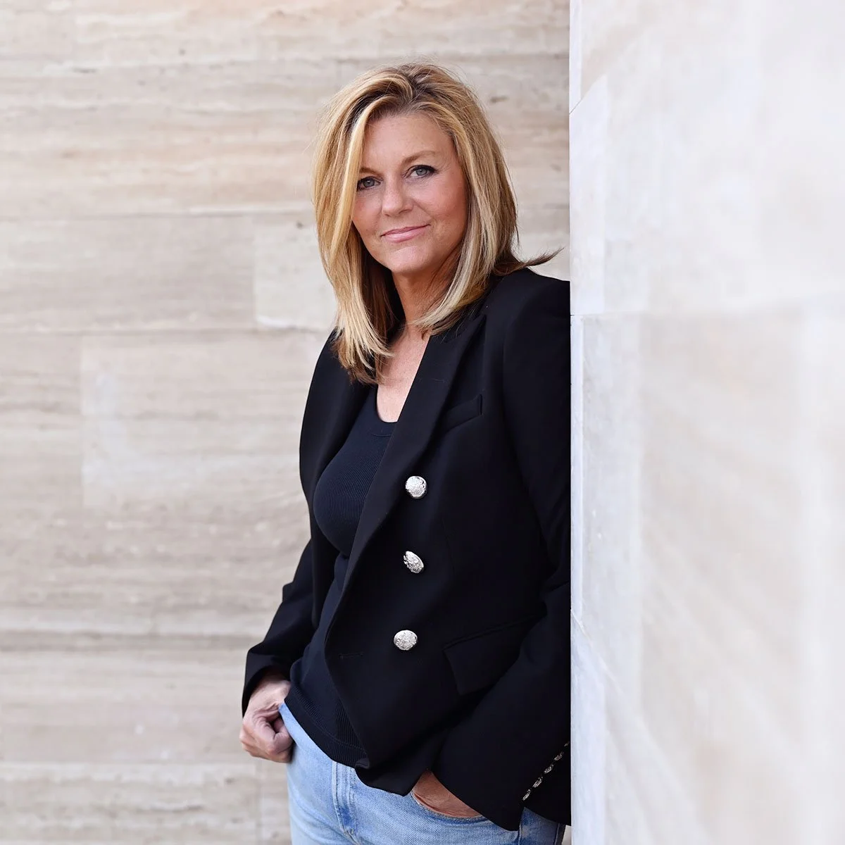 Wine leader Maria Ponzi leaning on a wall