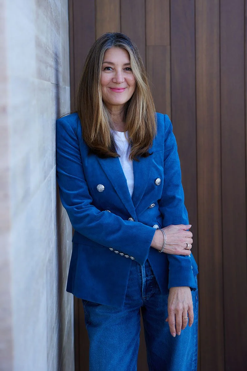 Beverage industry leader, Sue Martinez leaning on a wall