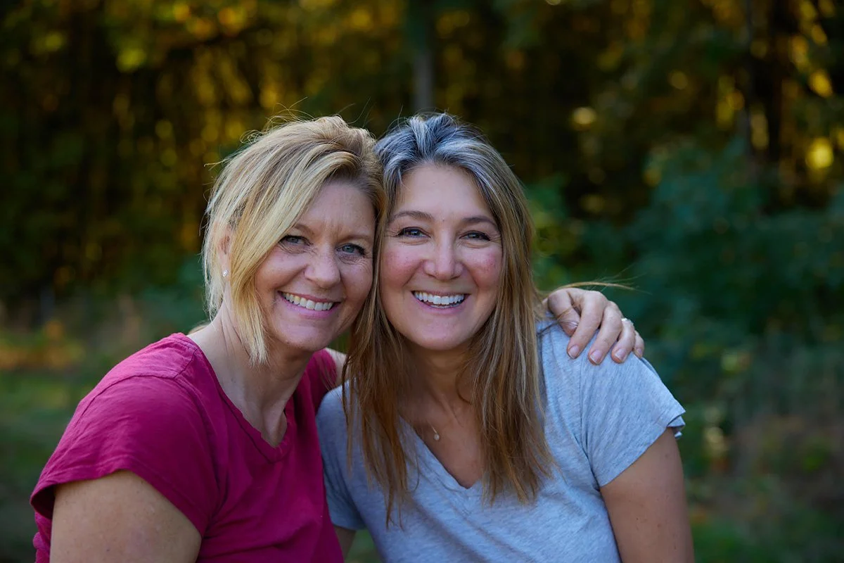 Two women hugging at harvest in the vineyard