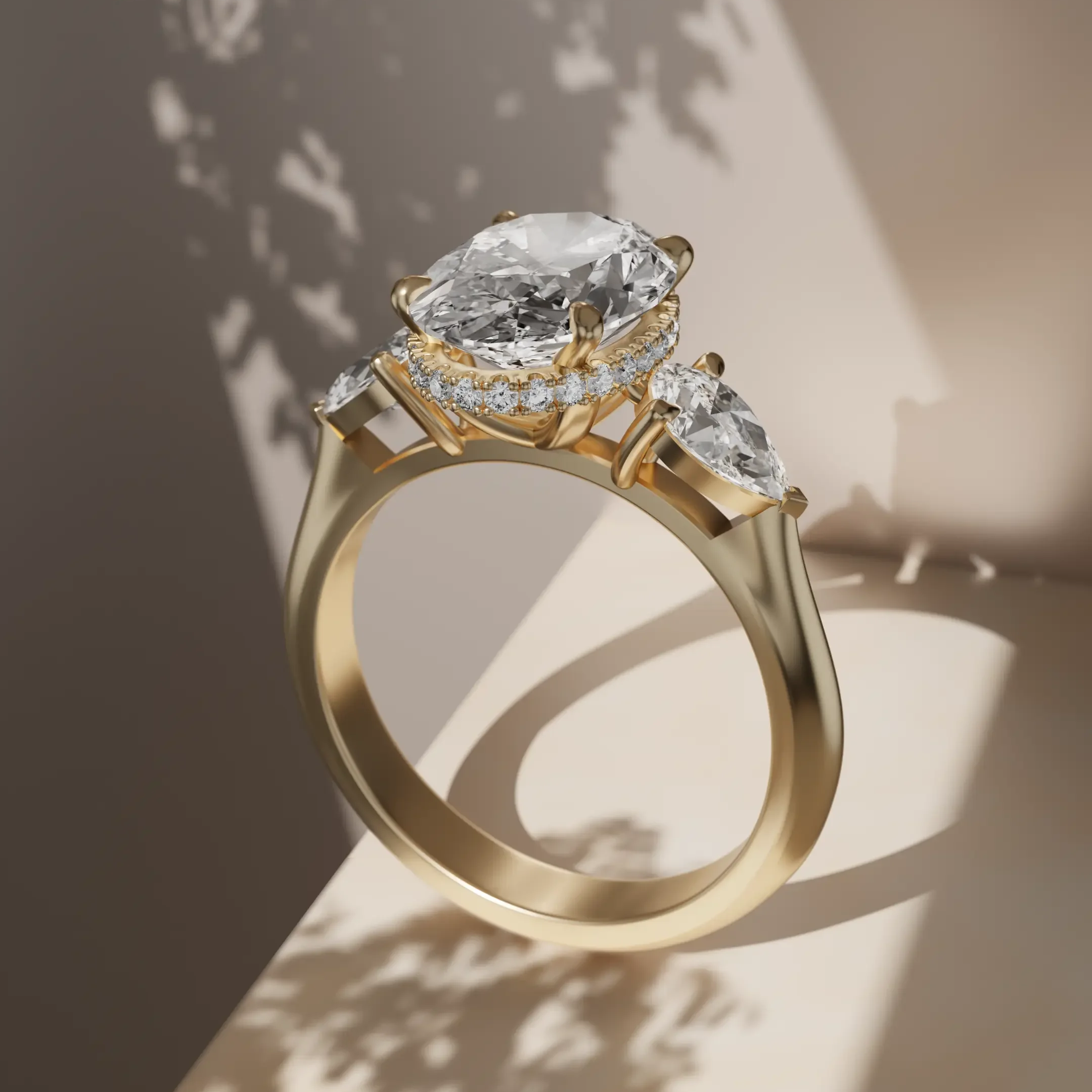 Trilogy in yellow gold 18K, oval centre stone in a hidden halo with two pear cut side diamonds. 
