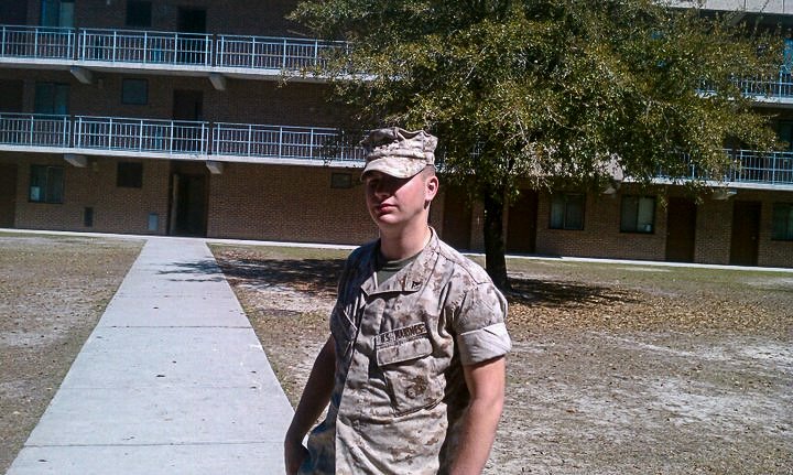 Snapshot of a Marine on an unidentified compound, wearing his camis.