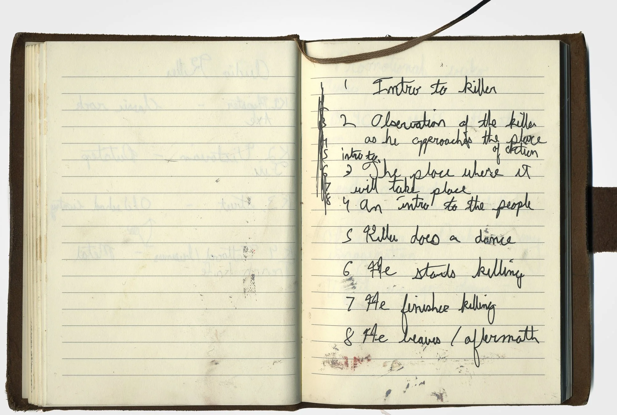 Moleskin notebook open to a page where someone has written an 8-part program/description of the planning and execution of a mass shooting.
