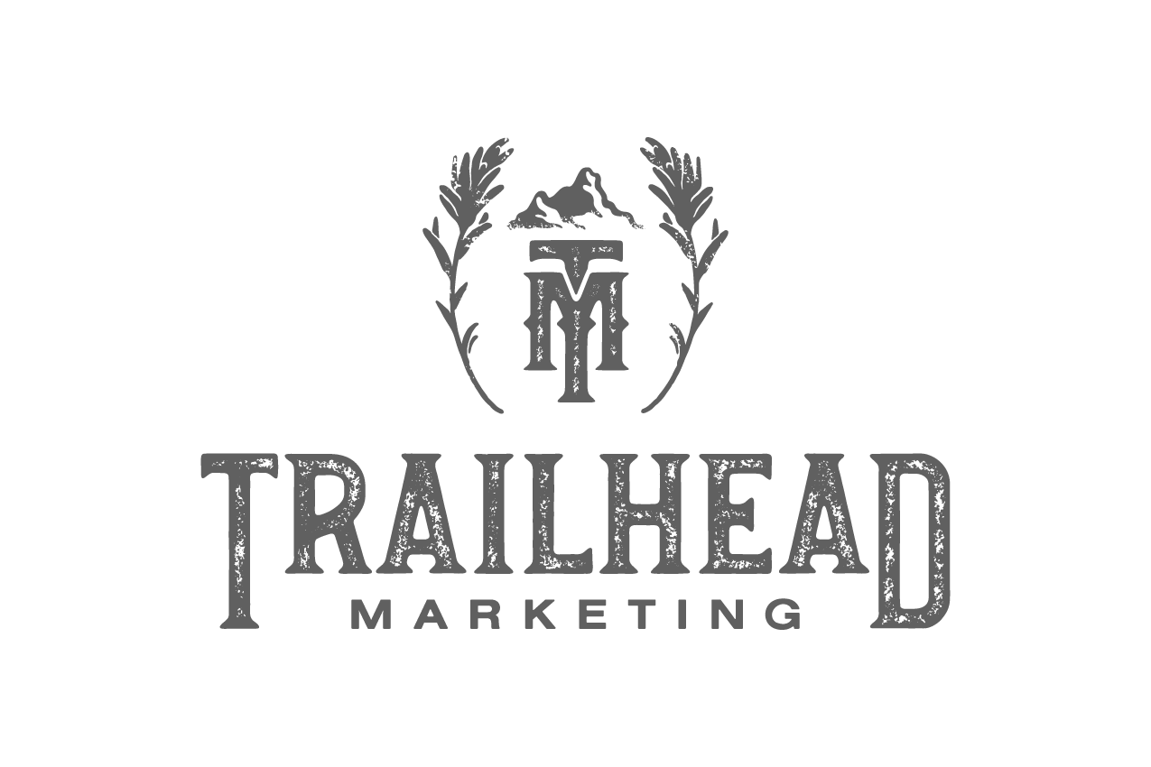 Trailhead Marketing logo with mountain, wheat branches, and stylized 'TM' monogram.