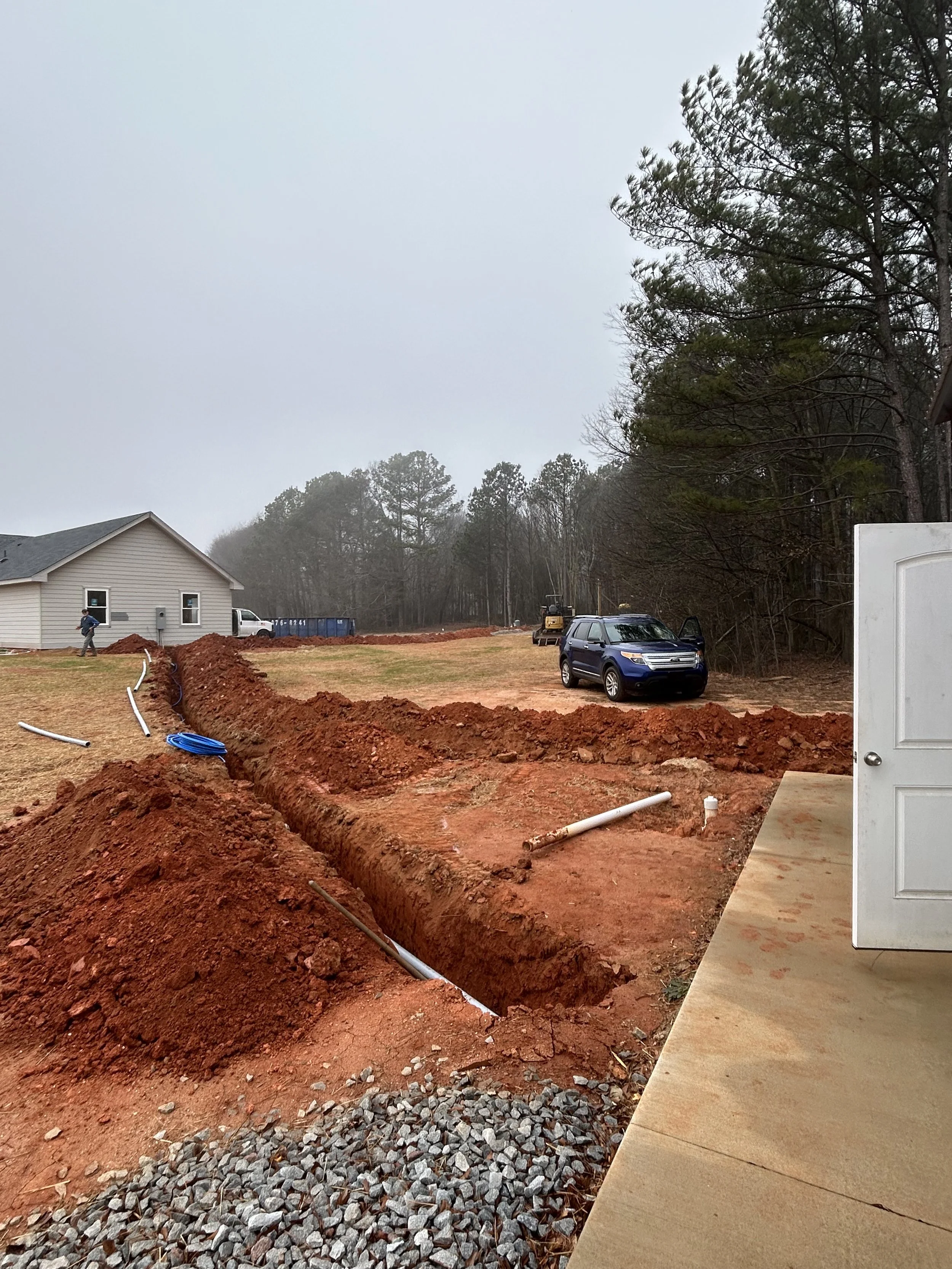 landscaping trenching excavation near me Hartwell georgia debris removal demolition pad site prep footers concrete drainage culverts French drain grading
