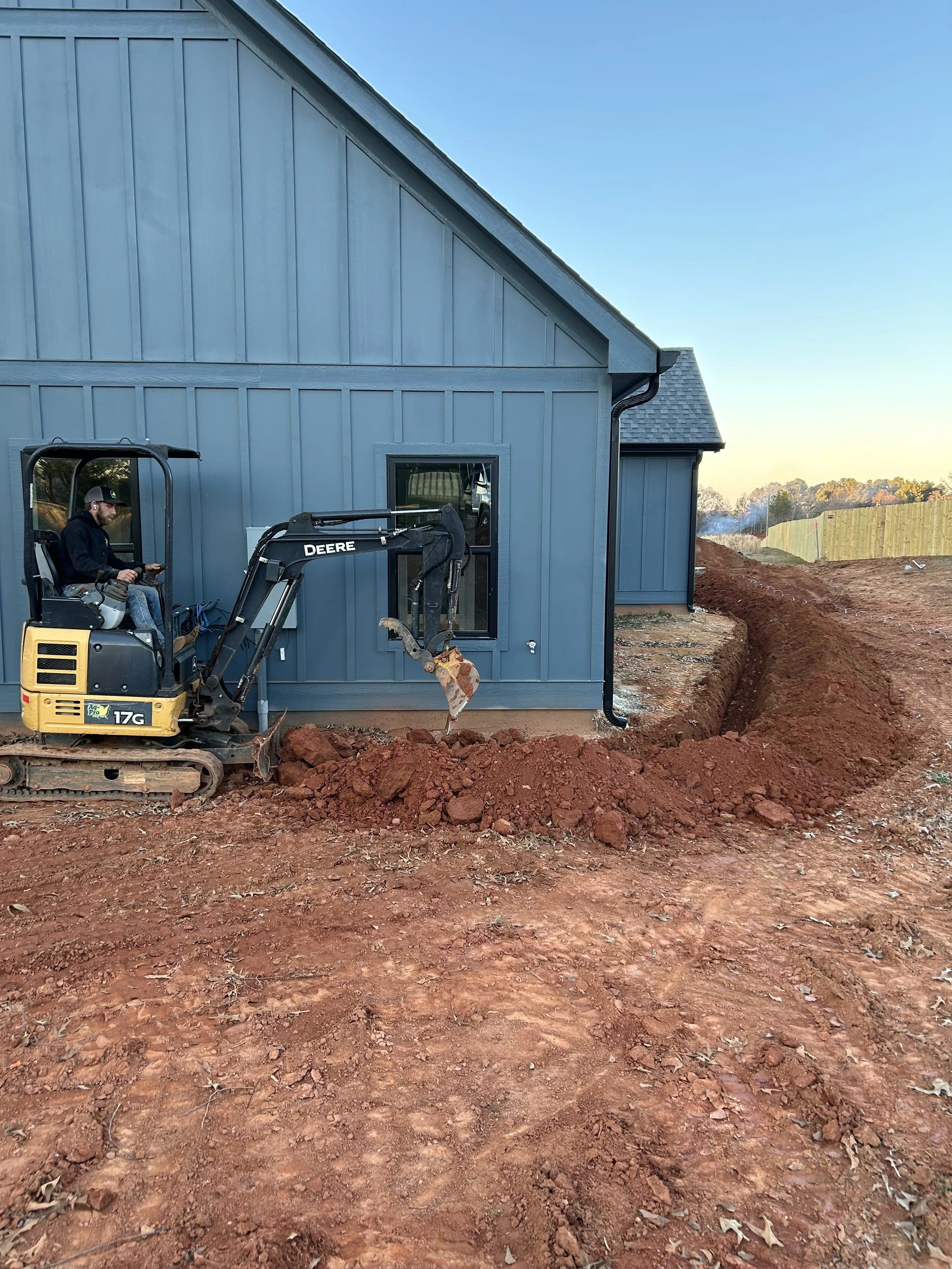 landscaping trenching excavation near me Hartwell georgia debris removal demolition pad site prep footers concrete drainage culverts French drain grading