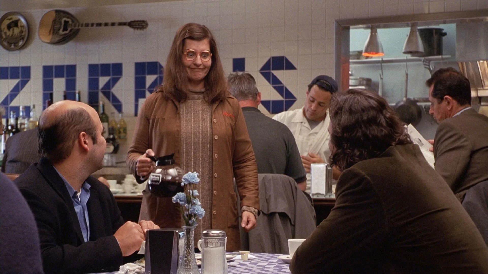 Toula serving customers at her family’s Greek restaurant in the movie "My Big Fat Greek Wedding."