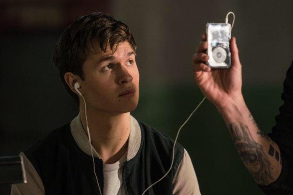 Baby has his headphones on in the movie "Baby Driver.”