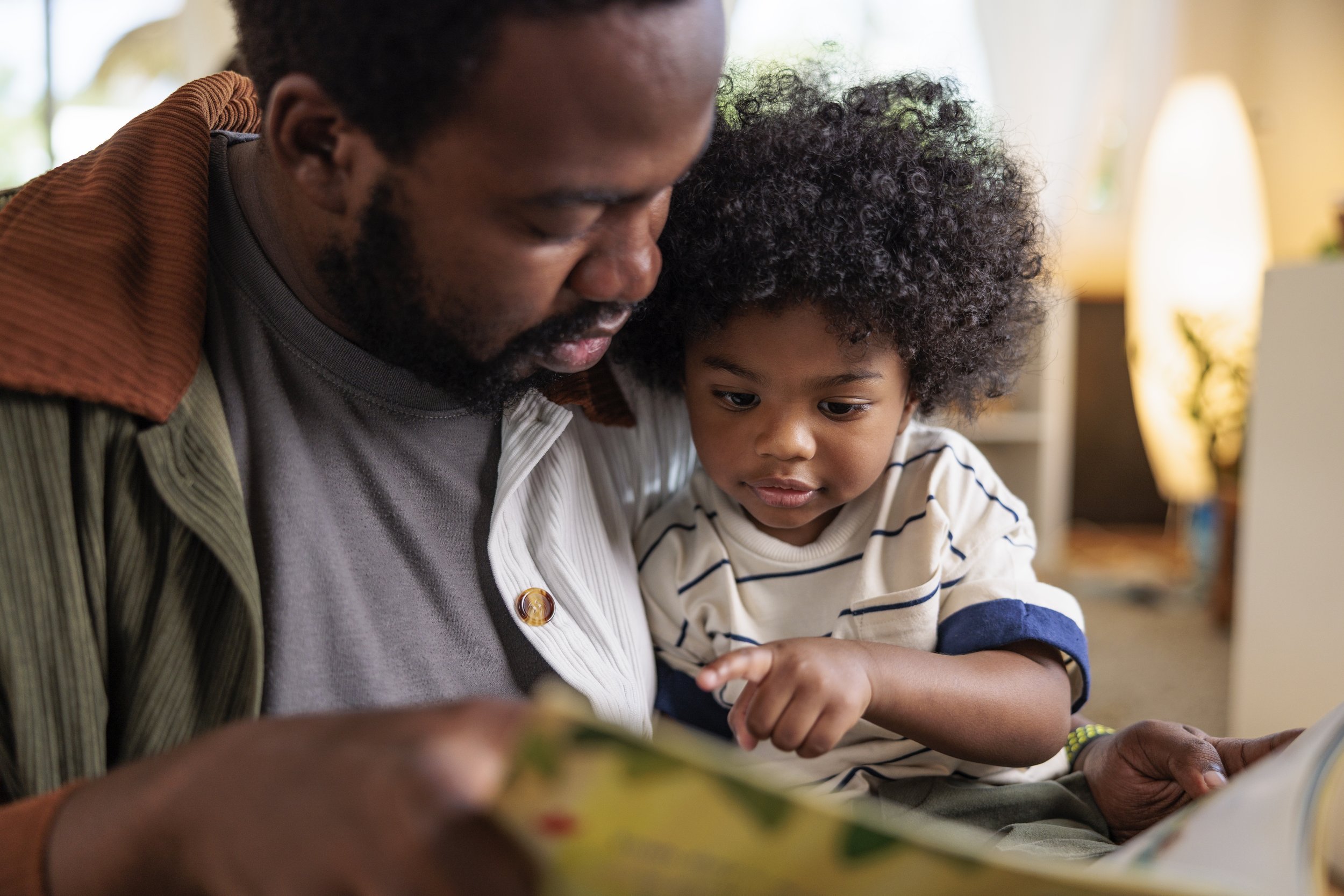 Daycare teacher reading to a baby