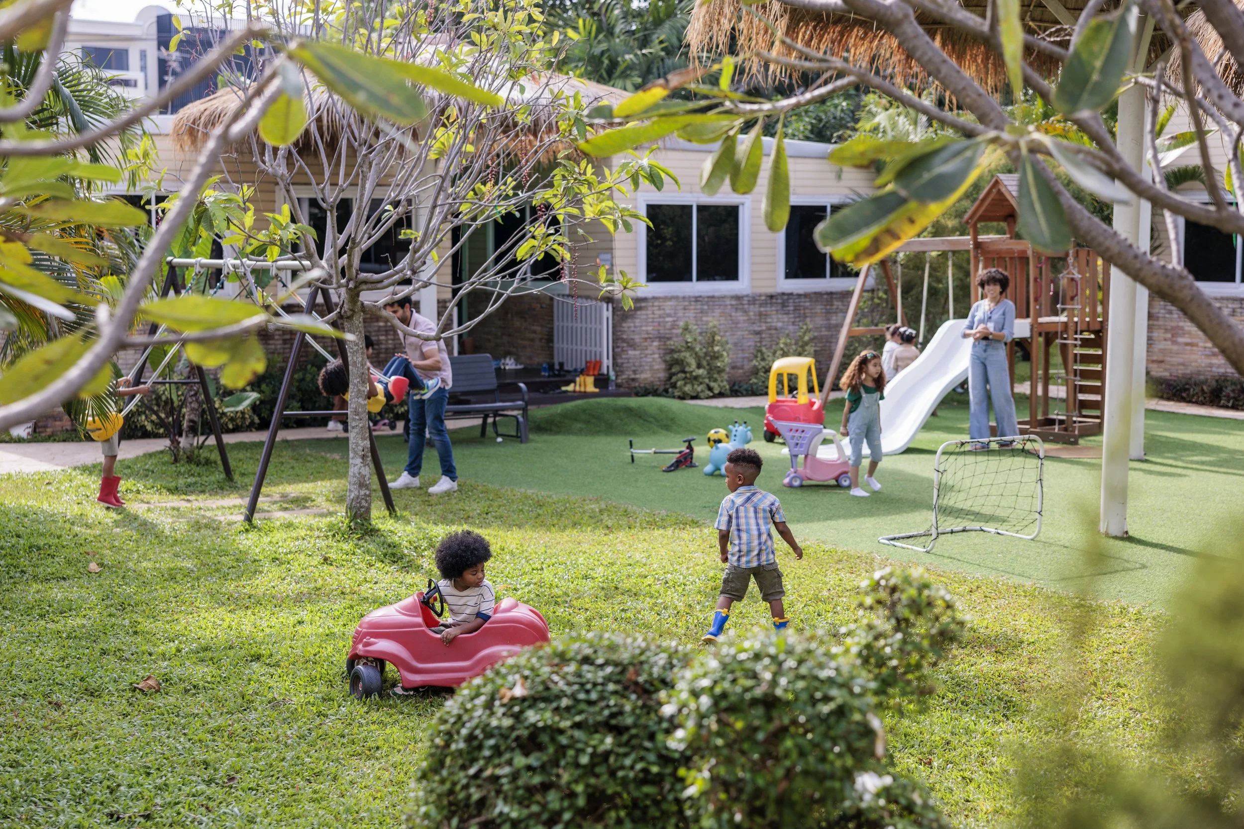 Daycare teacher and kids playing outside