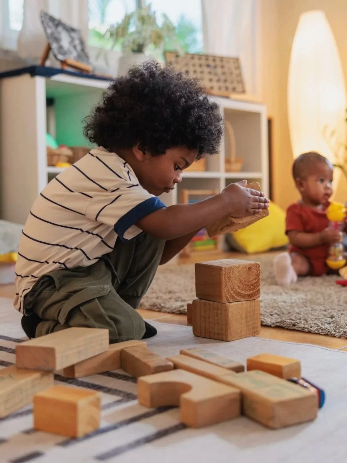 Toddler playing with wooden blocks