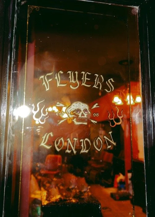 a door with flyers london logo, barbers in soho