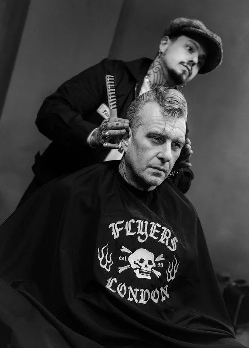 Ryan cutting a mans hair in flyers london, barbers in soho