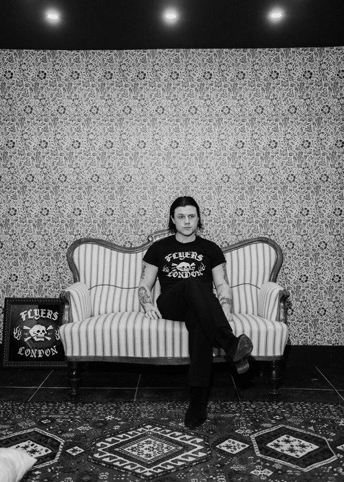 a man sitting in flyers london, barbers in soho