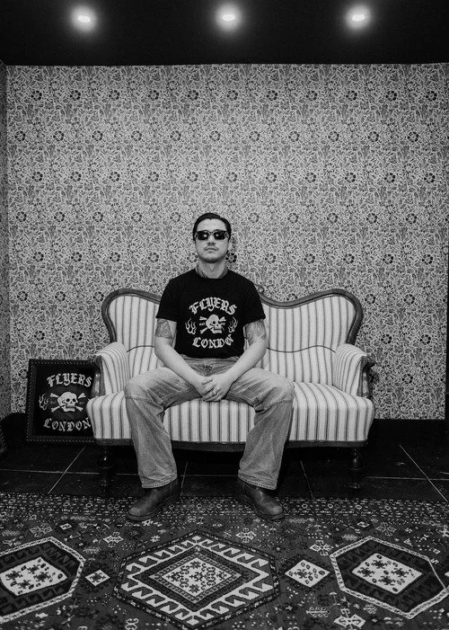 a man sitting in flyers london, barbers in soho