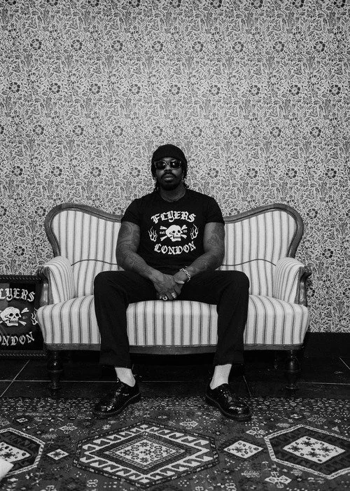 a man sat in flyers london, barbers in soho