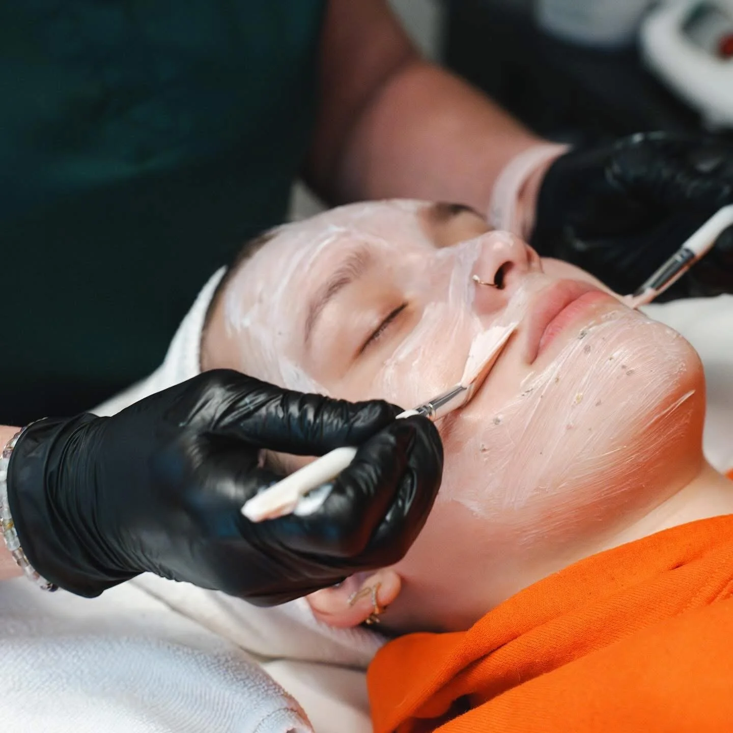 Woman getting facial treatment by licensed esthetician in Salem, OR.