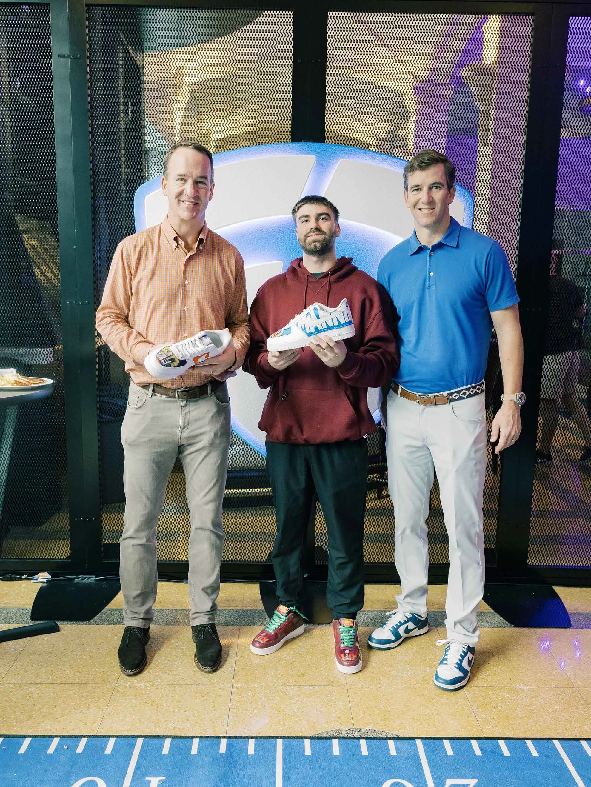 Peyton and Eli Manning commemorating their Super Bowl championship victories.