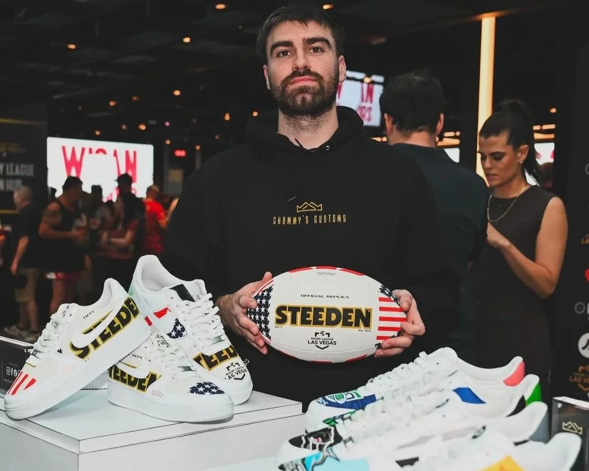 chummys customs holding offical rugby ball with other pairs displayed around him