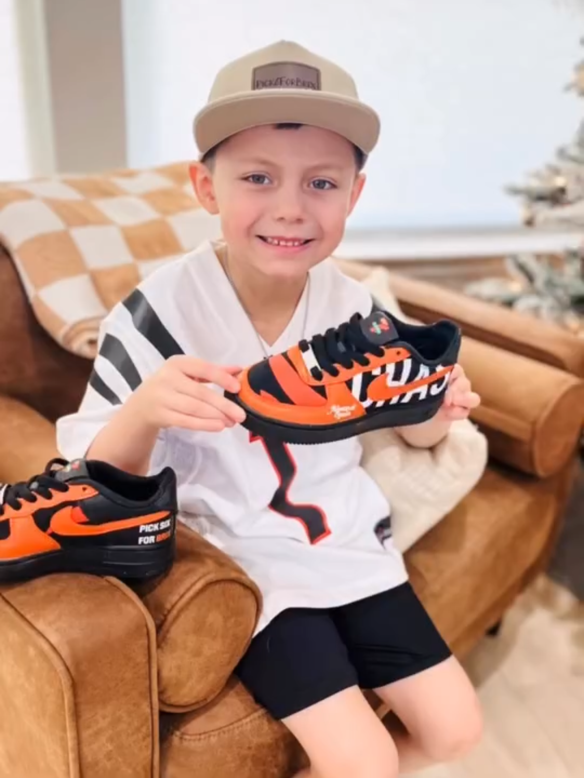 ja'marr chase biggest fan holding pair of chummys customs in collaboration with 7-eleven