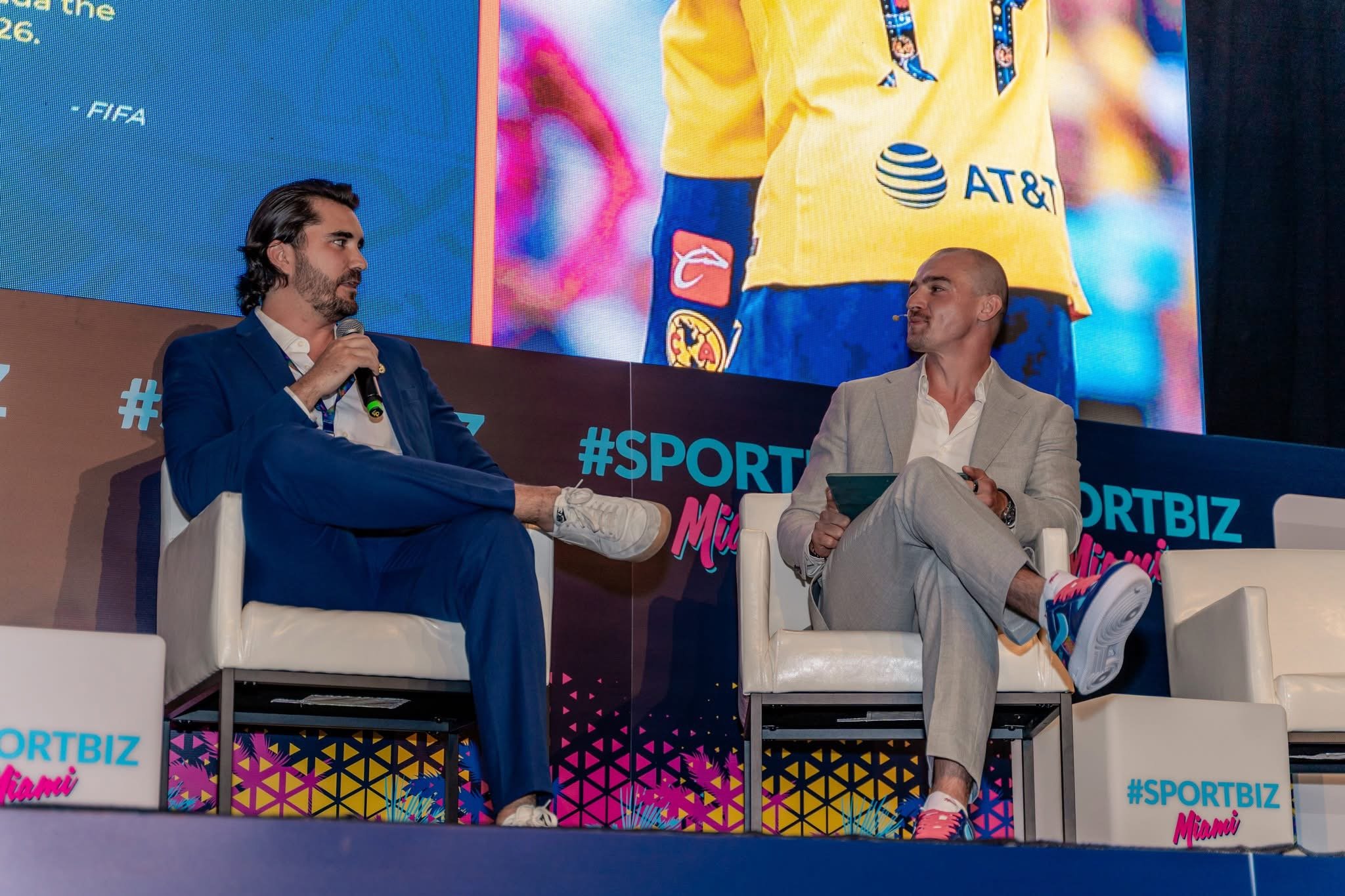 conference speakers wearing chummys customs sneakers on stage
