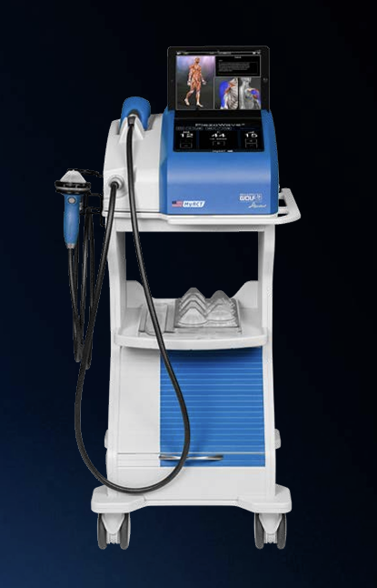 Medical shockwave therapy machine (PiezoWave2T MyACT) with a screen displaying a person, connected to a hand-held applicator and placed on a mobile cart.