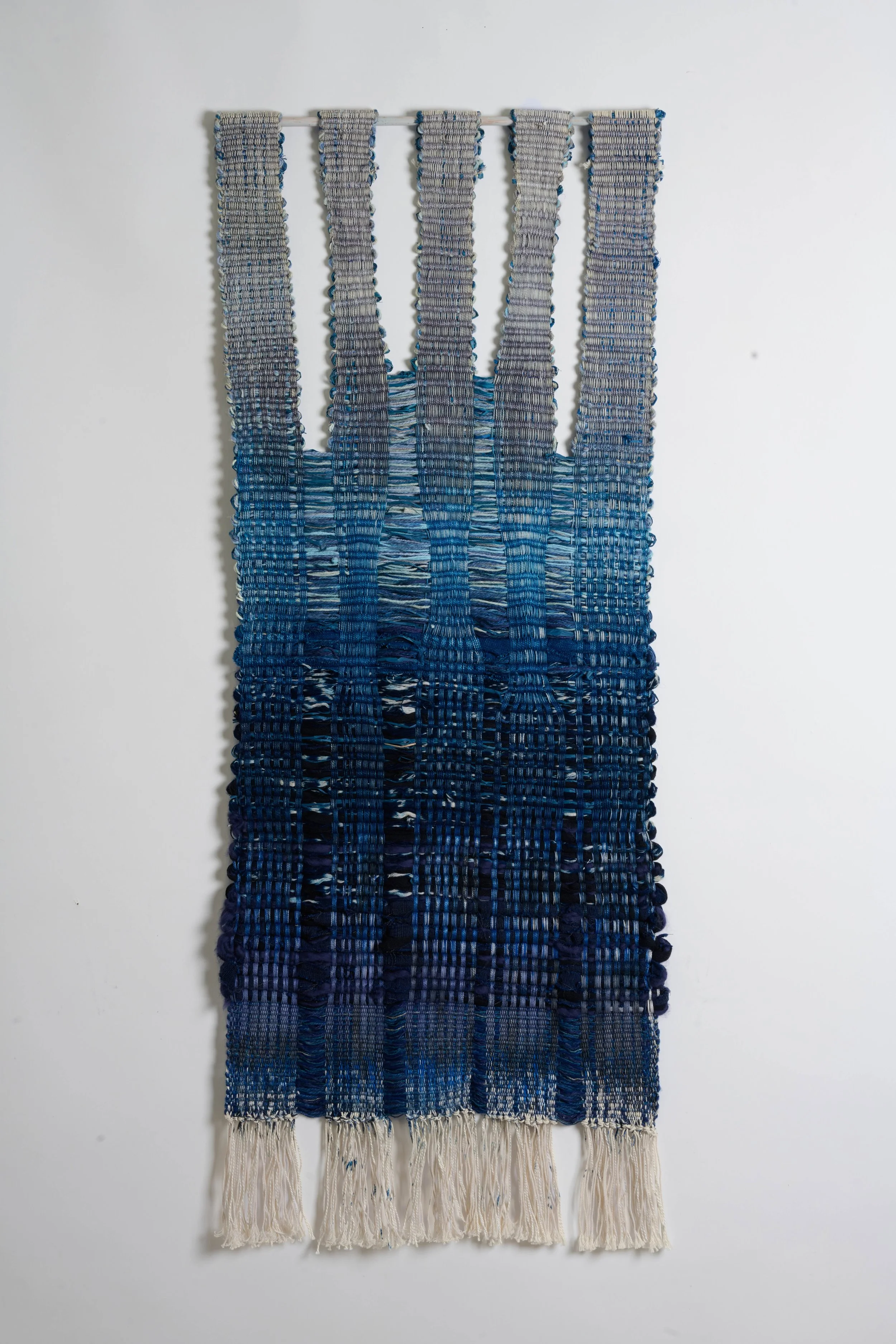 “Shield Indigo”, Raffia / Wool, 16x44 inches, 2025.