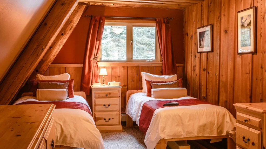 Guest bedroom with private ensuite at Silvertip's wilderness lodge.