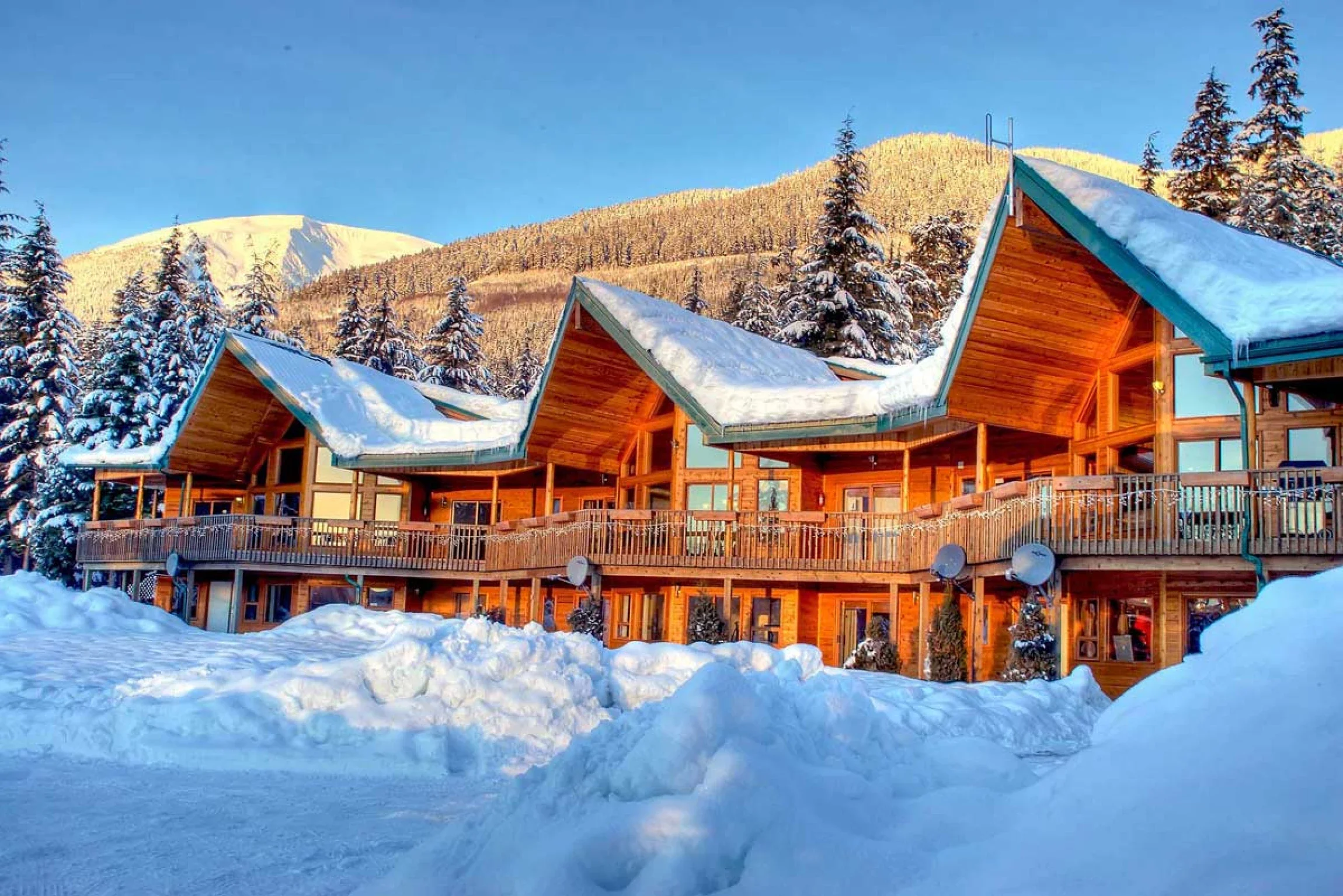 Yellow Cedar Lodge surrounded by deep snow on a clear winter day