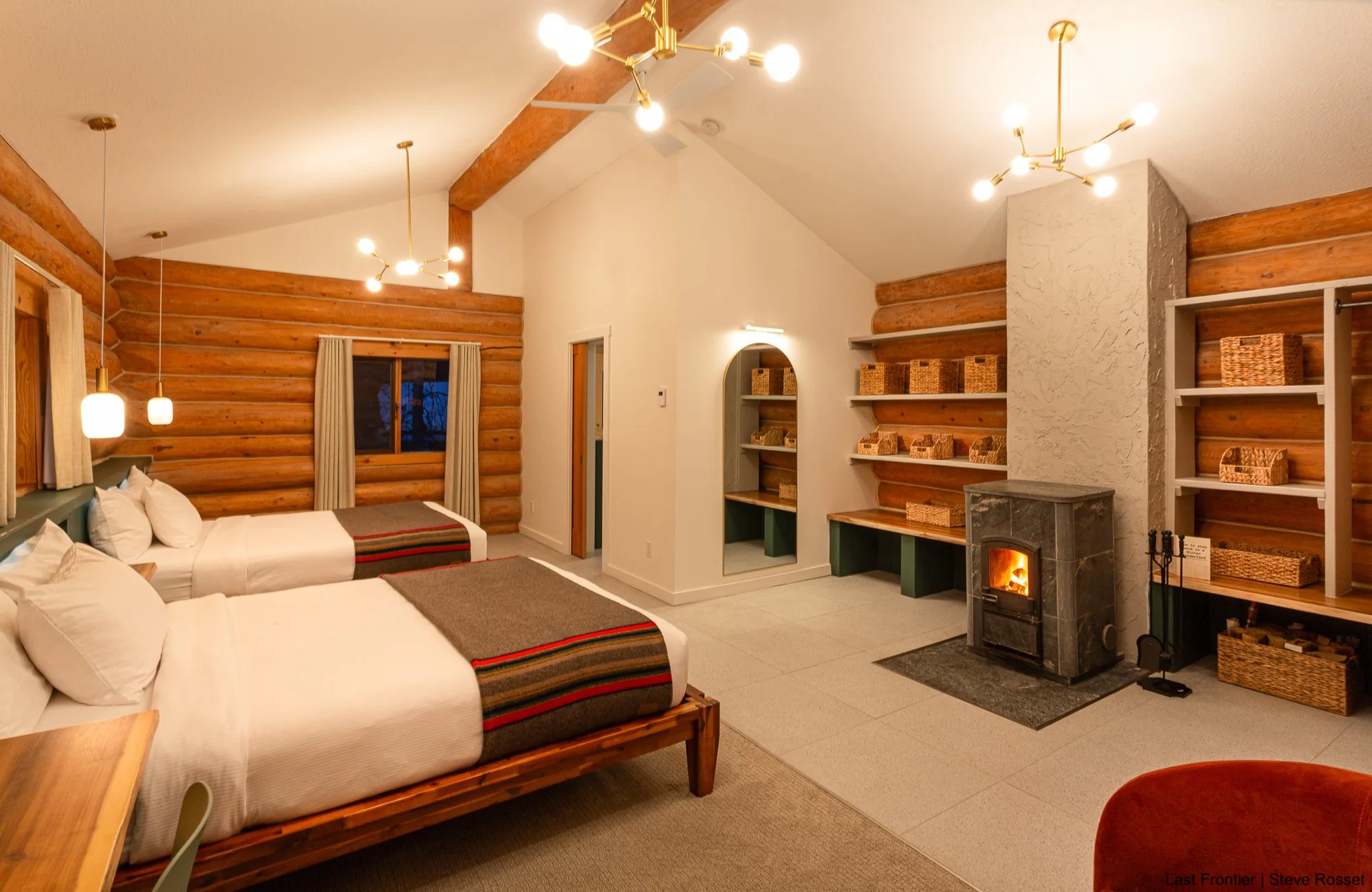 Guest bedroom inside the comfortable log chalet accommodations at Bell 2 Lodge.