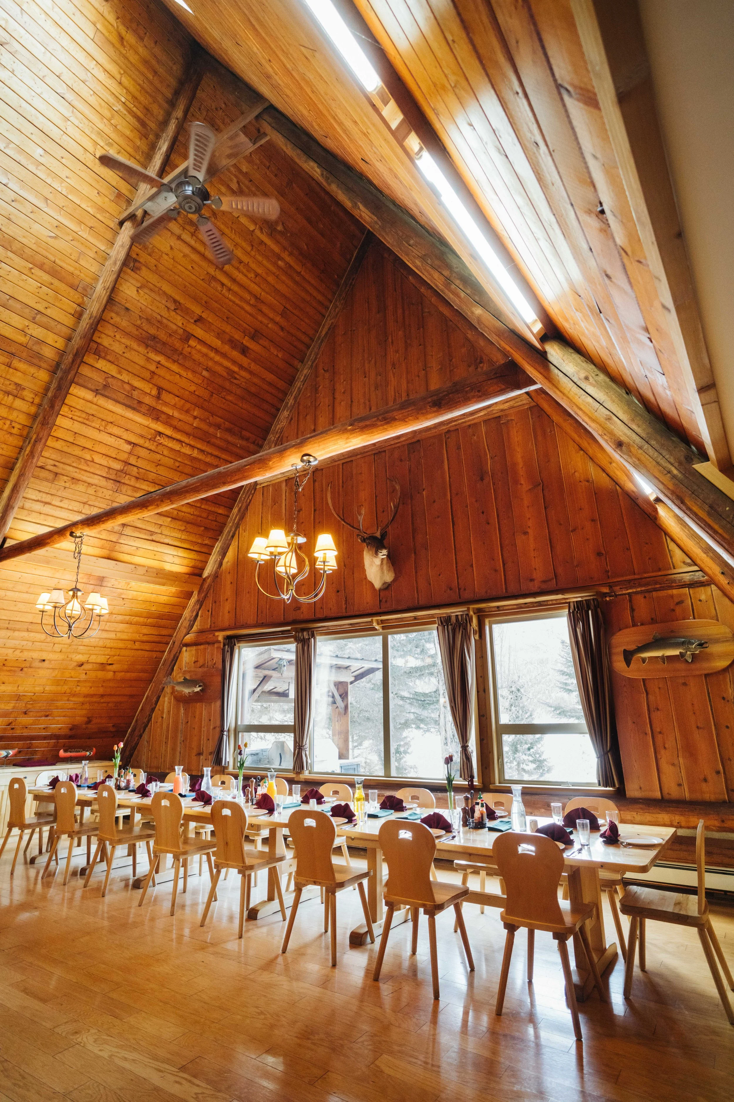 Dining room inside Silvertip's wilderness lodge overlooking Quesnel Lake.