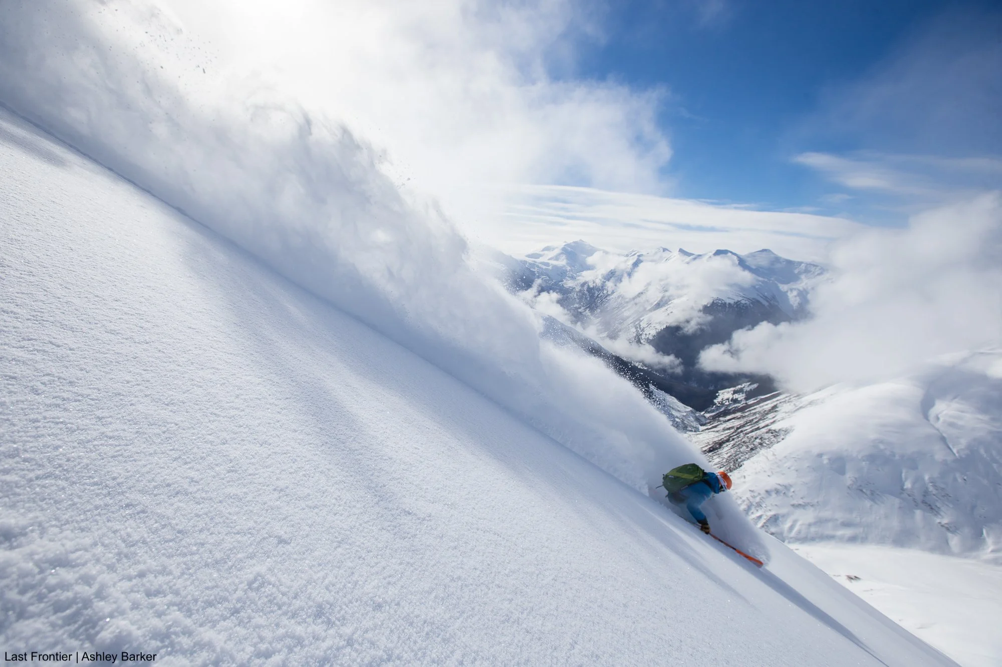 Skier carving through fresh powder at Bell 2 Lodge.