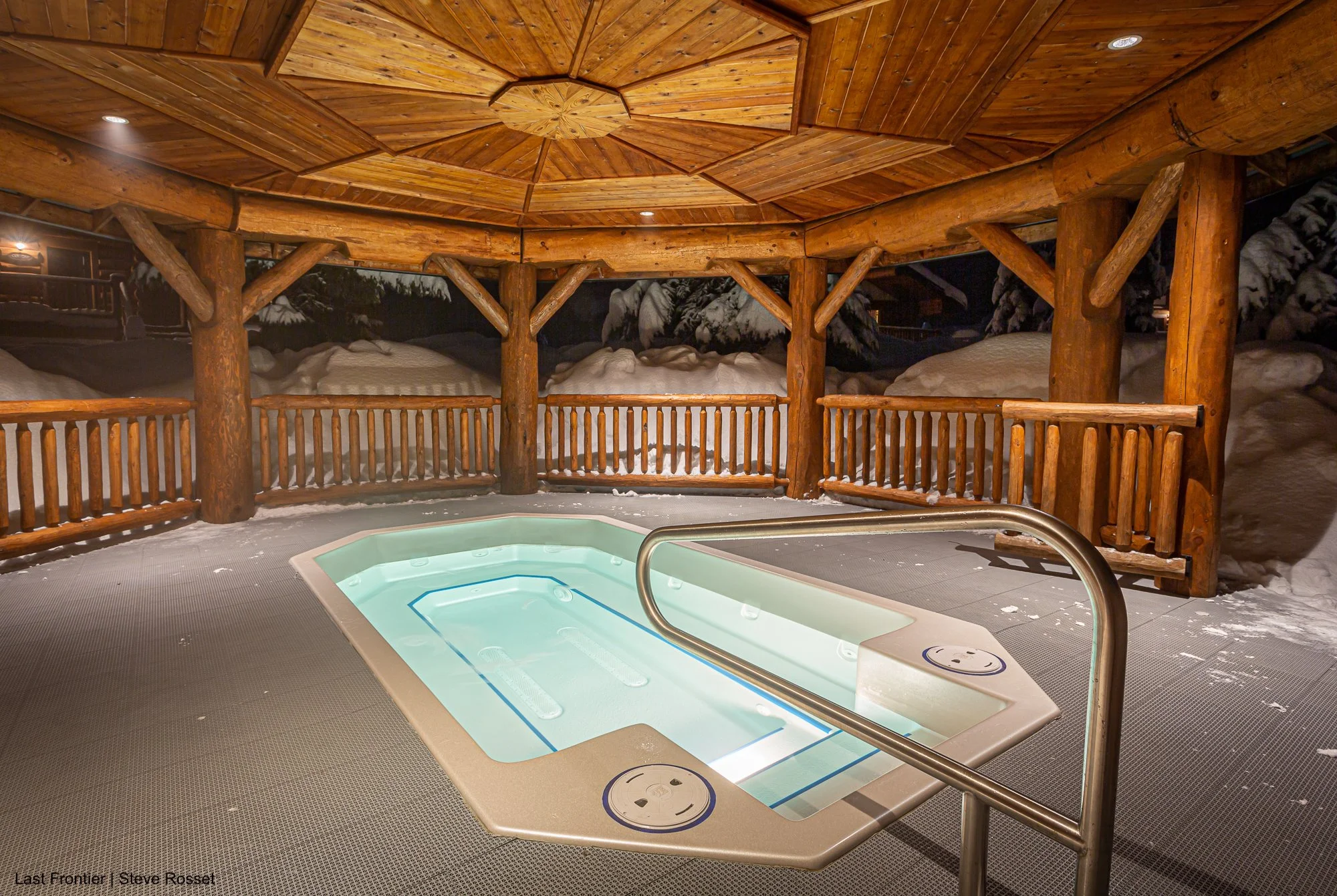 Relax in the outdoor hot tub at Last Frontier's Bell 2 Lodge.
