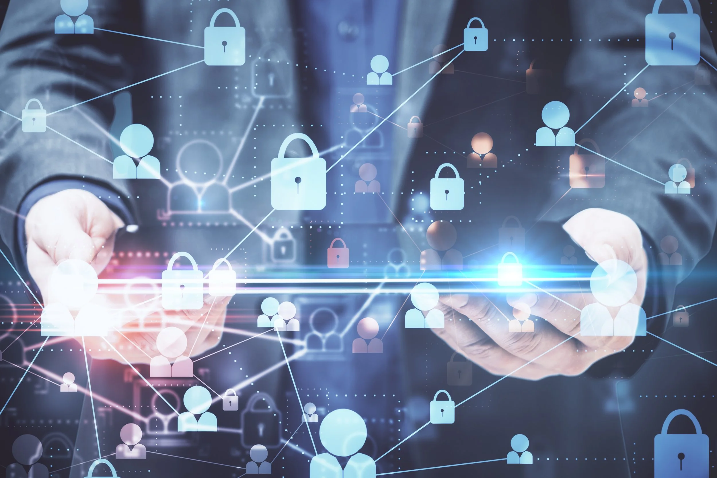 A person in a suit holds a transparent digital tablet with a virtual overlay of padlocks and human icons connected by lines representing cybersecurity and data protection.