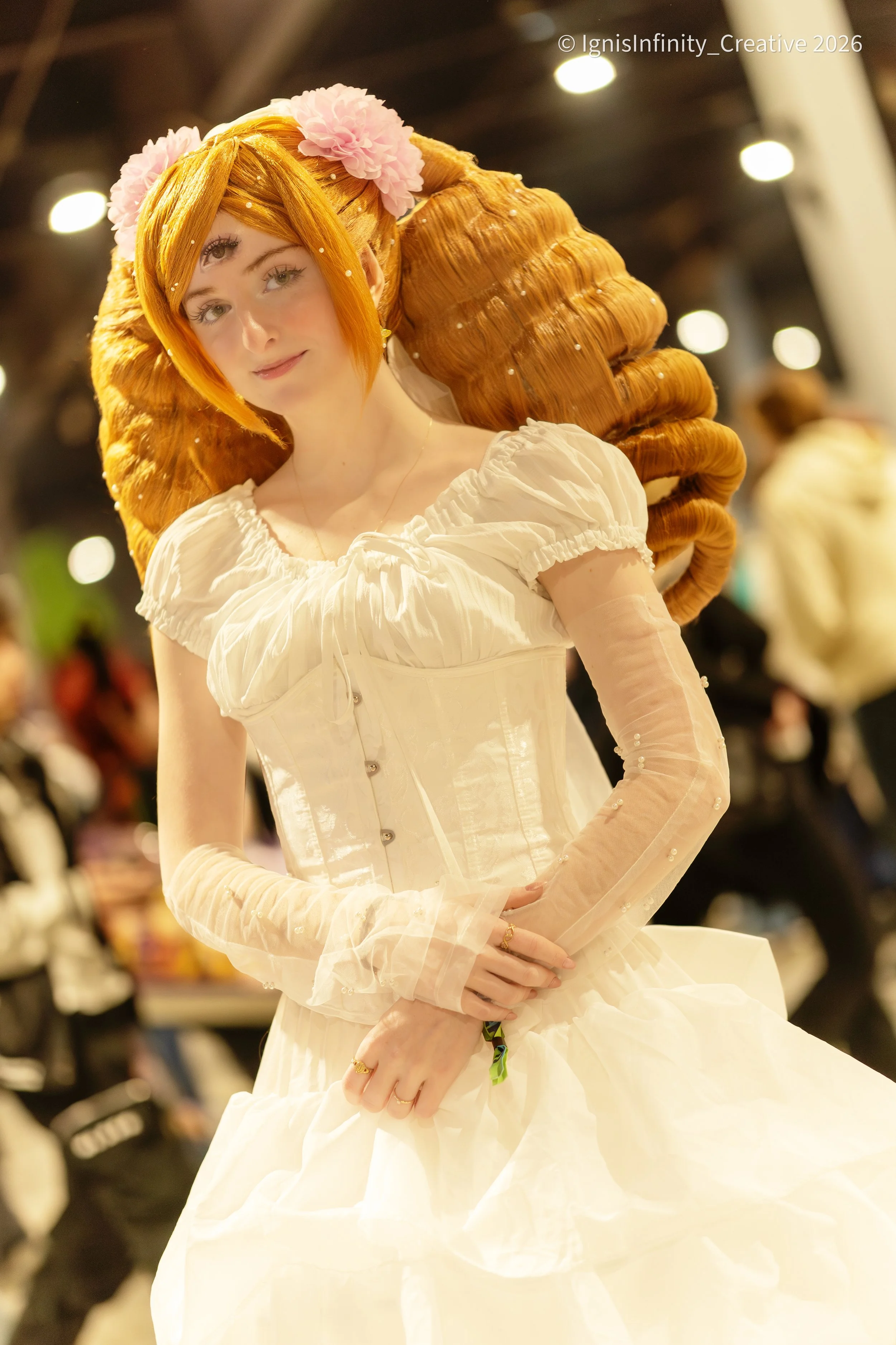 Charlotte Pudding (One Piece) with her third eye and drill hair – graceful white dress pose at convention. Photographer: IgnisInfinity Creative | Cosplayer: @Liamcos3