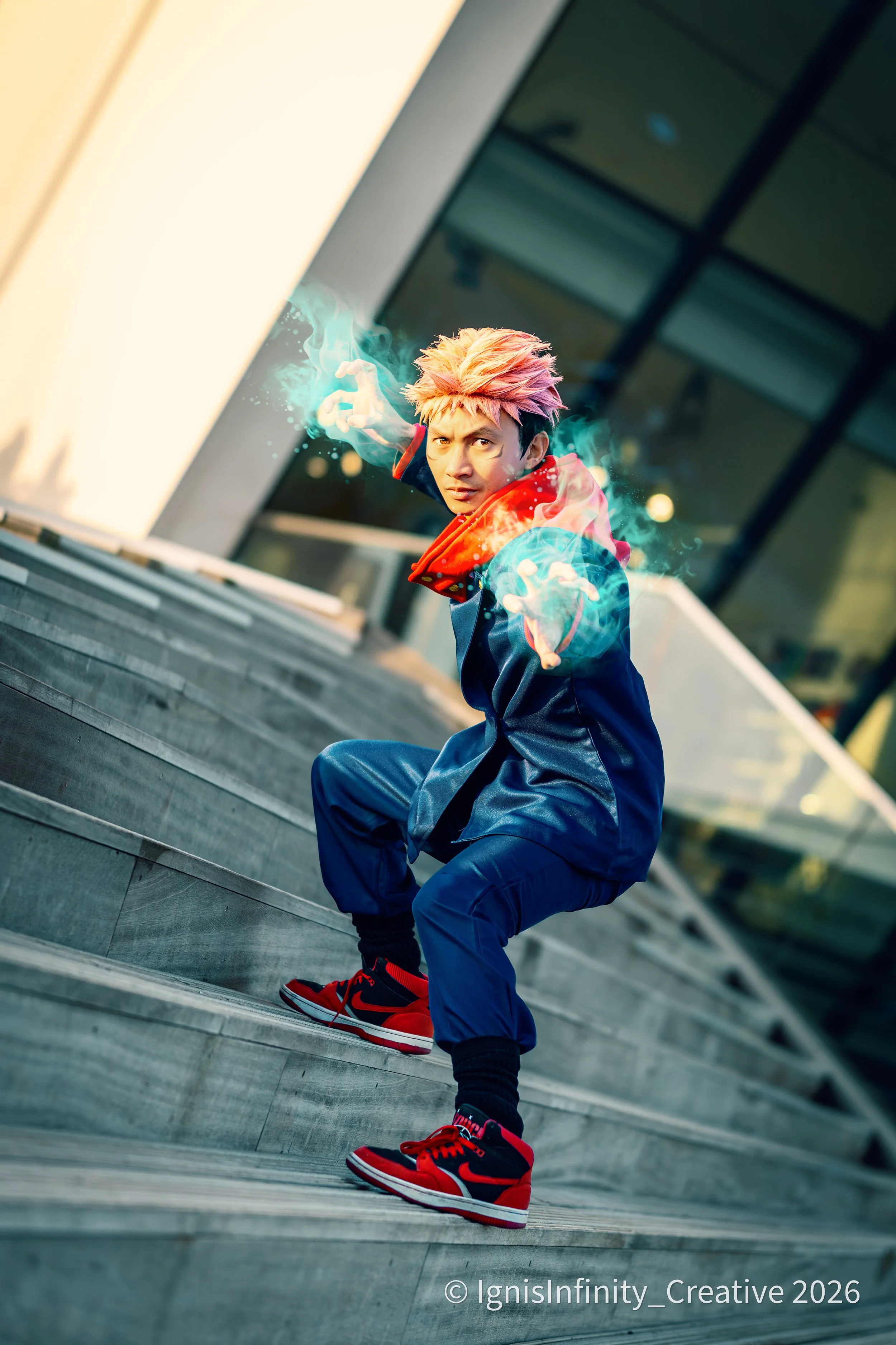 Intense Yuji Itadori cosplay from Jujutsu Kaisen featuring glowing cursed energy effects and action pose, captured in modern Amsterdam architecture. Professional shoot by Rotterdam-based cosplay photographer IgnisInfinity Creative.

