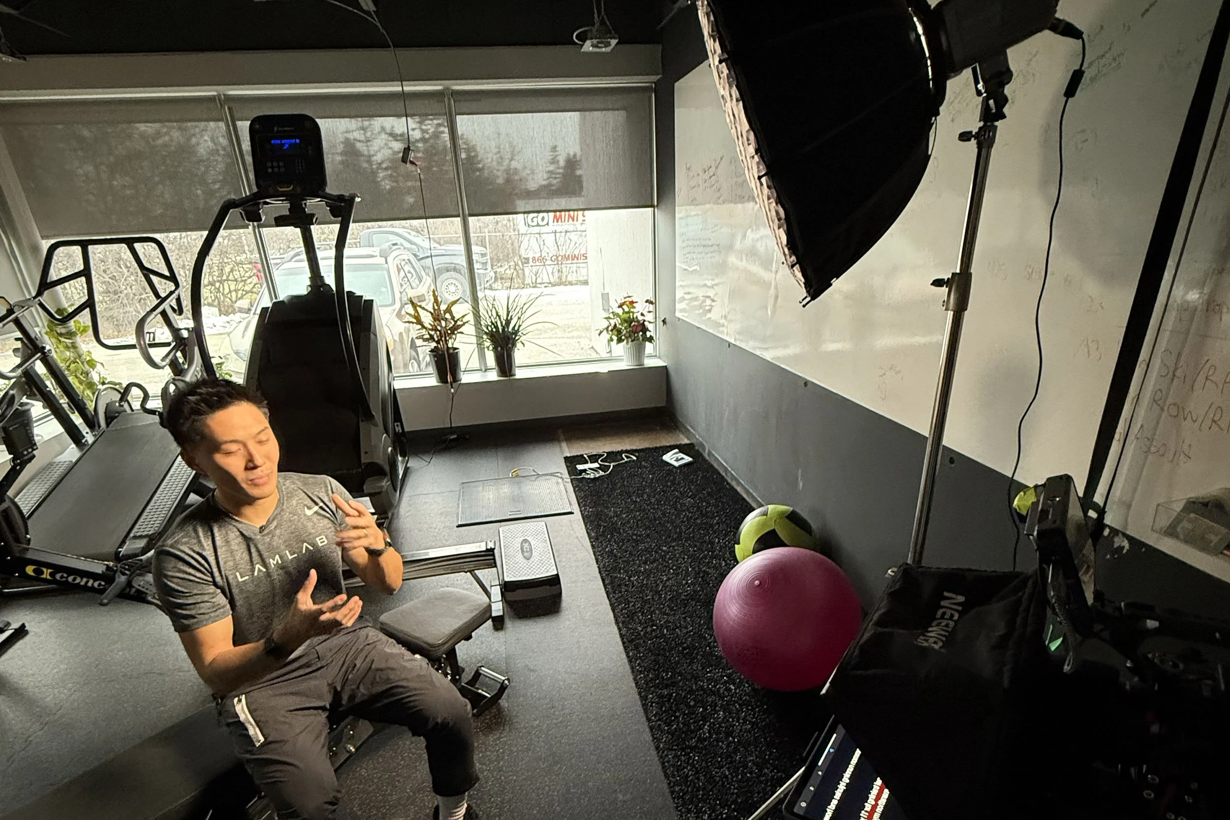 Deadline Creative filming branded fitness content with professional lighting and video production equipment inside a modern gym studio.