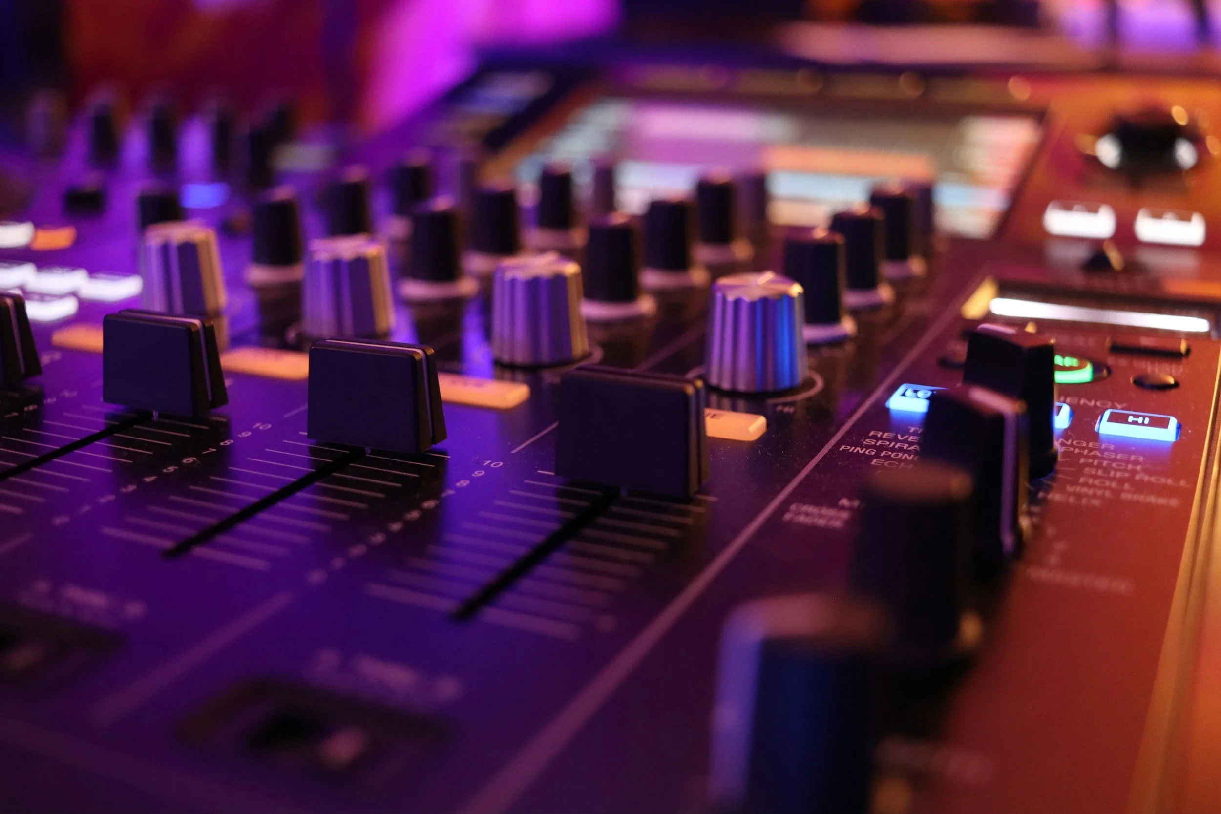 Close-up of a DJ mixing console.