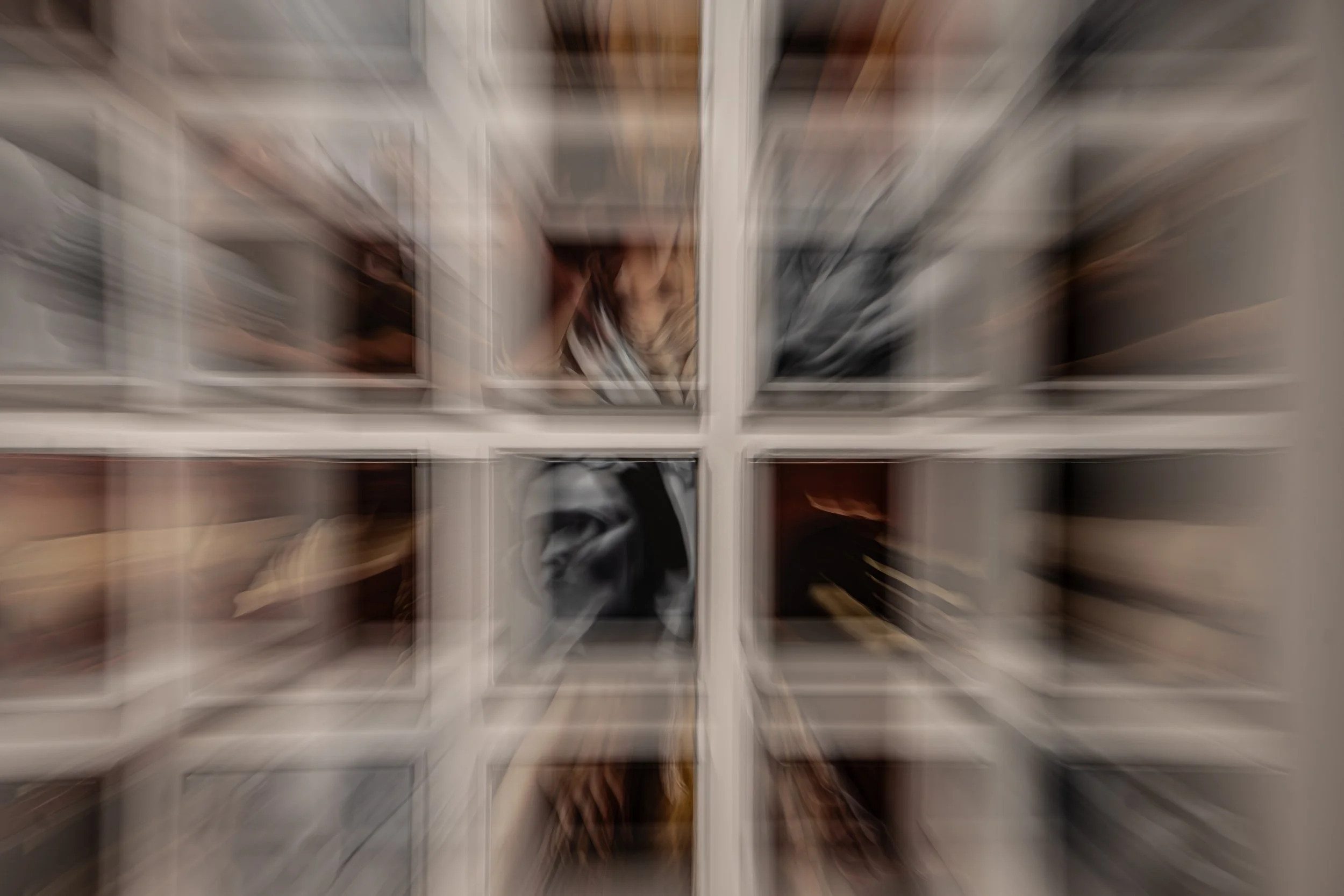 A gallery wall featuring multiple paintings, captured using in-camera movement and lens effects to create layered motion and repetition. The result transforms static artwork into a dynamic visual composition.