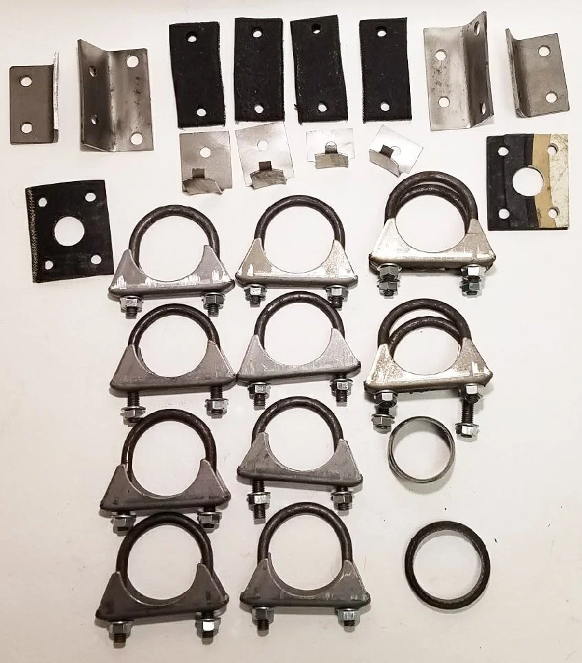 Complete NOS dual exhaust hanging hardware kit for 1966-1974 Avanti II, including rubber straps, gaskets, and U-bolts.