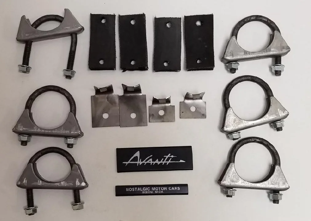 Complete NOS dual exhaust hanging hardware kit for 1975-1985 Avanti II, including rubber straps, gaskets, and U-bolts.