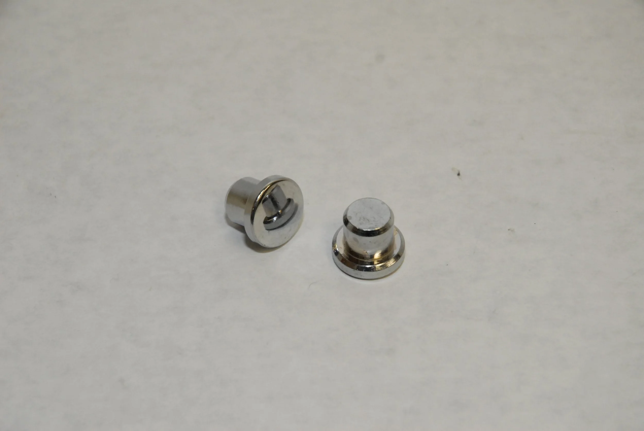 Pair of NOS Chrome Door Handle Lock Hole Plugs for 1976-1983 Avanti II restoration.