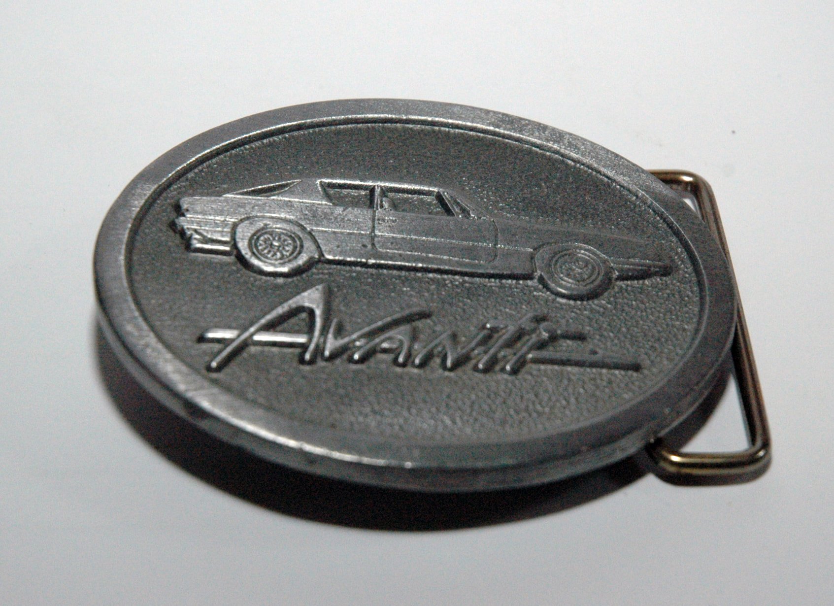 Limited edition pewter-colored Studebaker Avanti belt buckle, 3-inch factory original collectible.