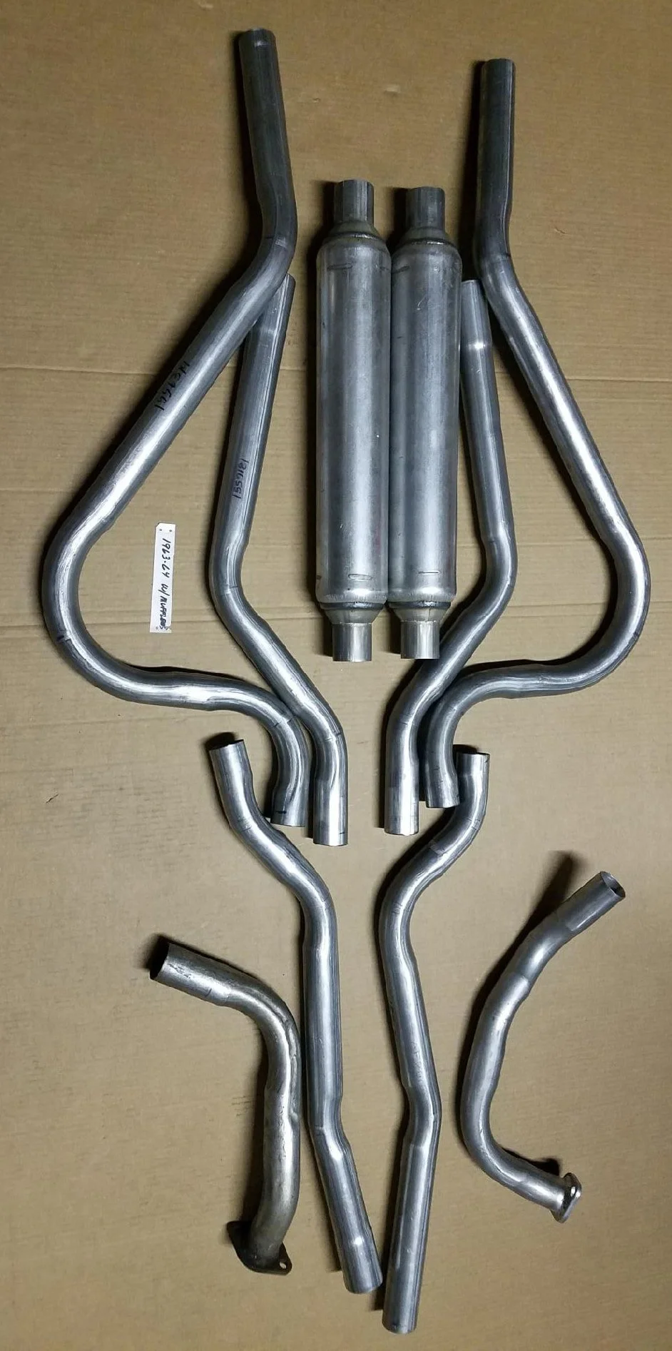 Complete 10-piece 409 stainless steel dual exhaust system with round seamless mufflers for 1963-1964 Studebaker Avanti.