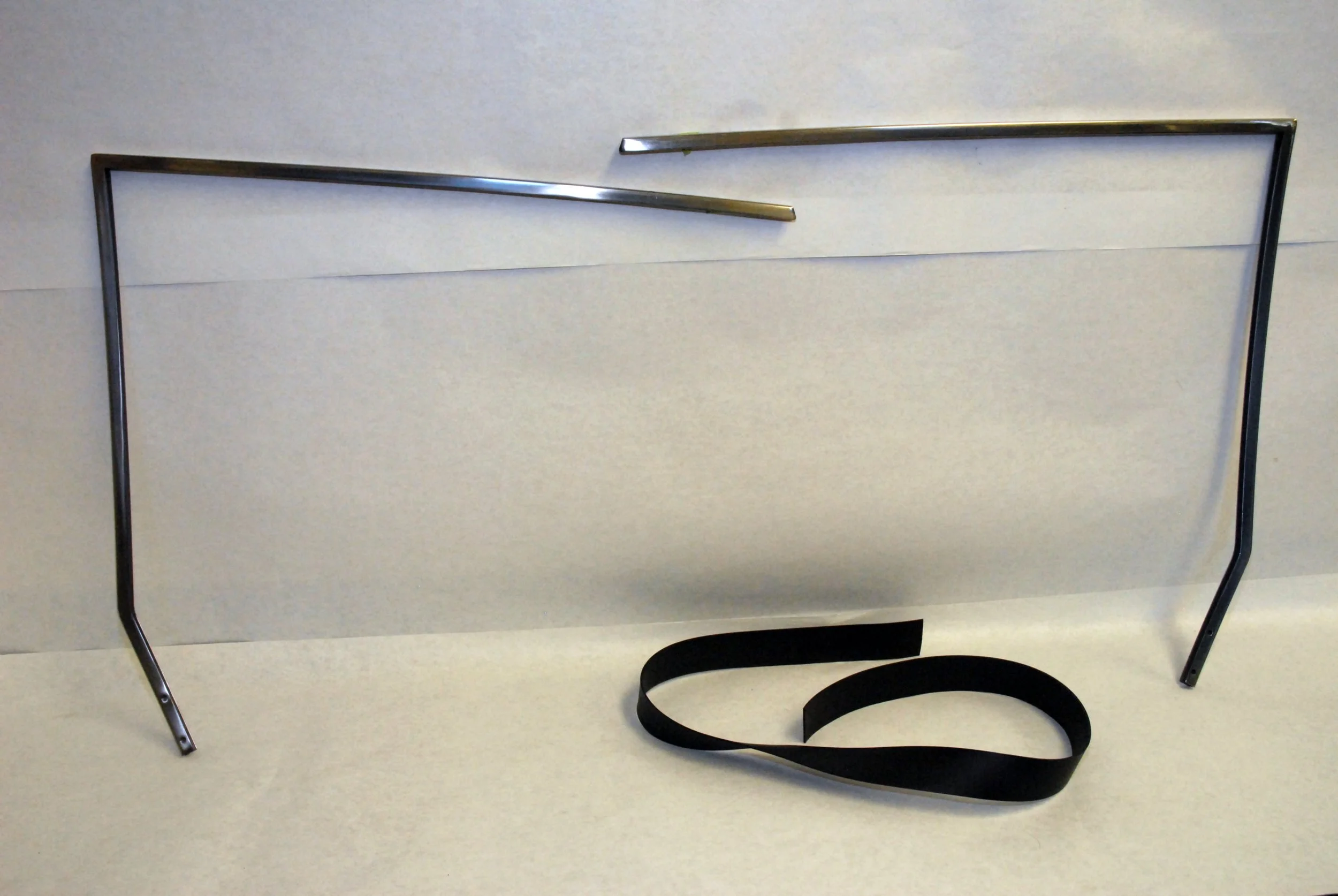 NOS Stainless and Black Door Glass Frames for 1963-1988 Studebaker Avanti with installation cushion strip.
