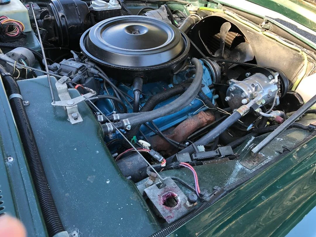 1981 Avanti engine bay with original 305 V8 engine and cold A/C system.