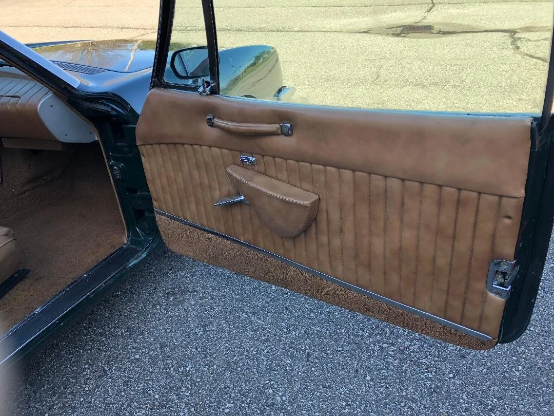 Factory tan leather interior door panel for a 1981 Avanti II.
