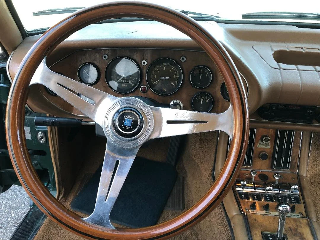 Genuine Nardi wood-rimmed steering wheel detail inside a 1981 Avanti.