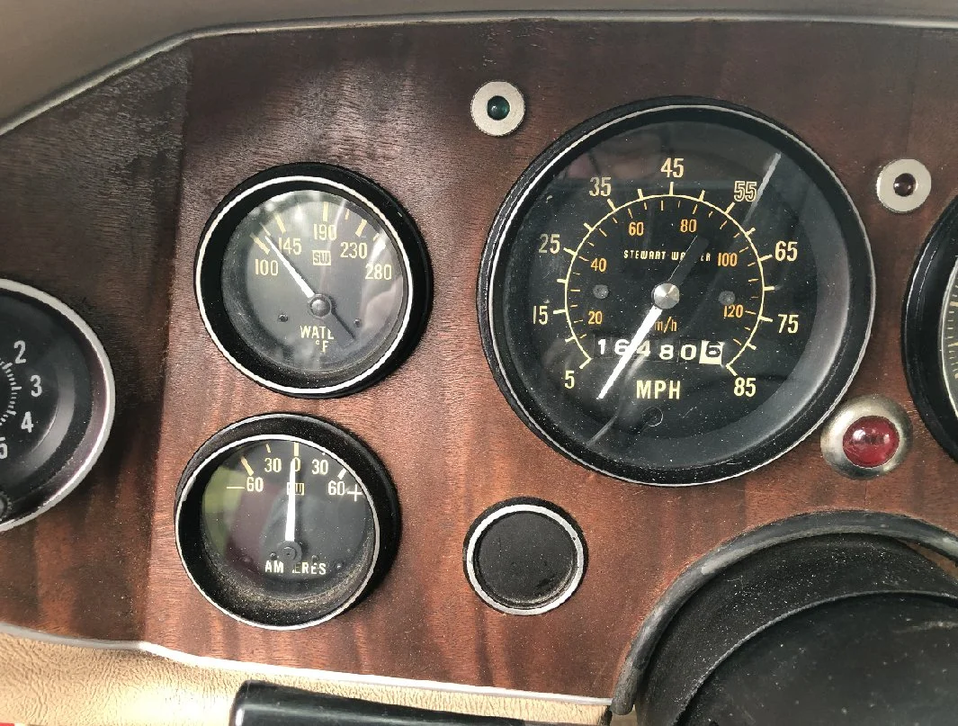 View of the 1983 Avanti dashboard with authentic wood grain trim and gauges.